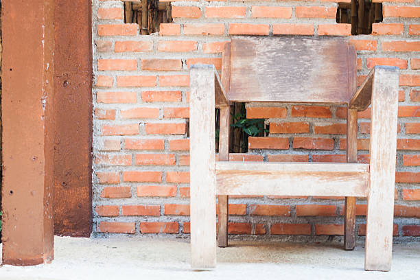 istock Wooden chair with red bricks wall 498453324