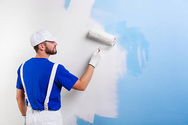 istock painter in white dungarees, blue t-shirt 498454428