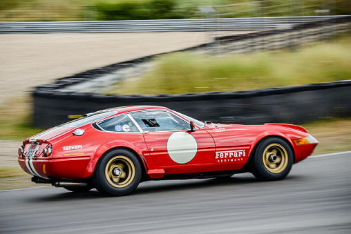 Zandvoort, The Netherlands - June 29, 2014: Ferrari 365 GTB/4 Competizione Daytona 1970s race car driving through a corner on the Zandvoort race track during the 2014 Italia a Zandvoort day. The Ferrari 365 GTB/4 Competizione was a successful race car with GT class wins in 1972, 1973 and 1974 at the the 24 Hours of Le Mans. The Daytona nickname comes from  Ferrari's 1-2-3 finish in the February 1967 24 Hours of Daytona.
