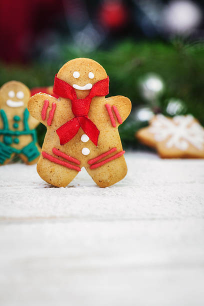 istock Christmas gingerbread  men cookies on white wooden board 498455790