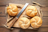 Kaiser rolls with knife and cutting board