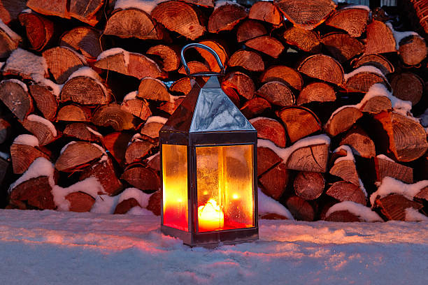 istock Storm lamp in winter, woodpile 498457908