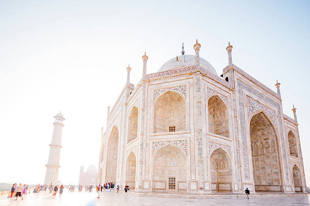 Colored background for themes about India - Silhouette of word famous Taj Mahal in Agra, India - seen from an usual standpoint at the banks of Yamua River.
