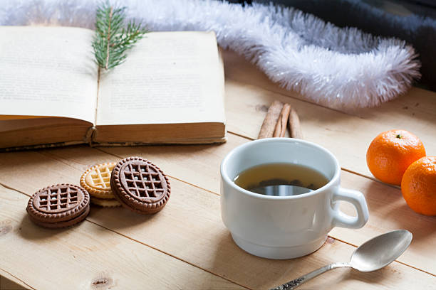 istock Cup of hot tea with books on wooden table. 498459162