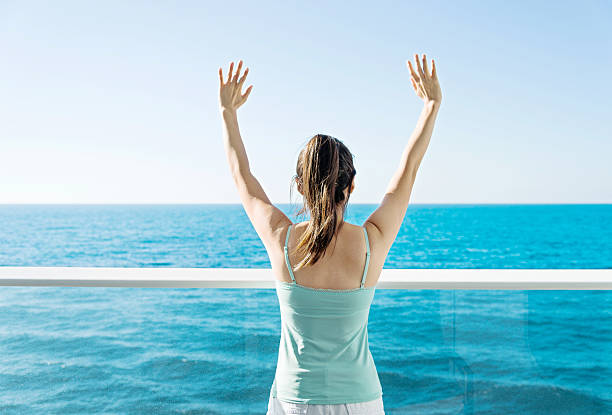istock Woman open arms on cruise 498459280