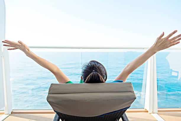 Cheering woman open arms on cruise.