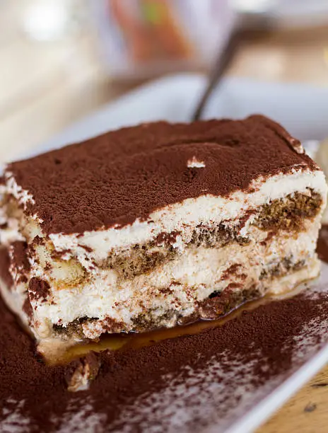 Delicious portion of tiramisu, ready to eat.