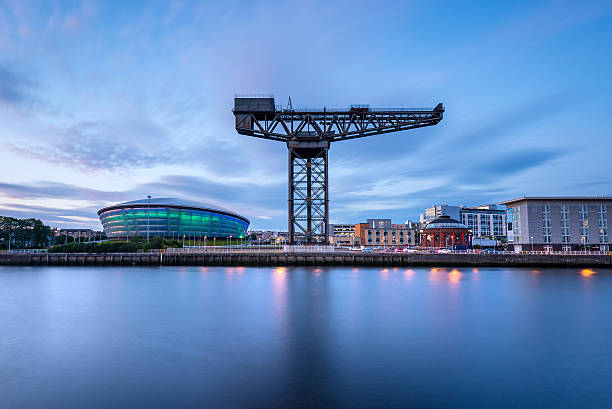 Finnieston Crane and SSE Hydro, River Clyde, Glasgow, Scotland, UK Wide angle view of the Finnieston Crane and SSE Hydro arena on the banks of the River Clyde at dusk. Glasgow, Scotland, UK, Europe. image created 21st century blue architecture wide angle lens stock pictures, royalty-free photos & images