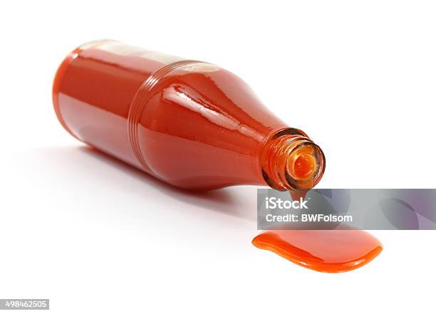 Hot Sauce Spilling From Bottle Stock Photo - Download Image Now - Hot Sauce, Bottle, Spilling