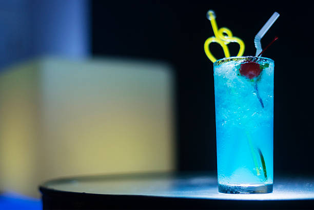 istock blue curacao cocktail drink with cherry at night 498462792