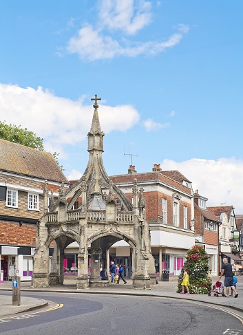 Salisbury, United Kigdom - August 26, 2012: Central street with 15th-century Poultry Cross (market cross) and people going by