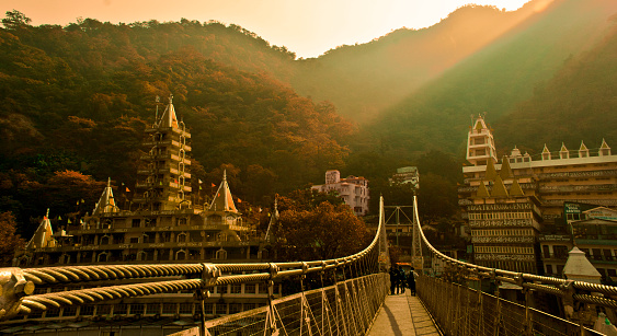 Bridge connecting two hills separated by river Ganga, famously know as Ram Jhula, situated in Rishikesh, India. Its also the spiritual, Yoga and Meditation capital of the world.