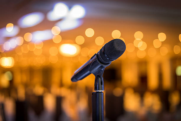istock Wireless microphone stand on the stage venue with blur background 498467136