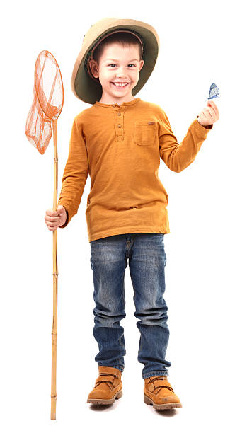Boy caught an butterfly and and holding it proudly