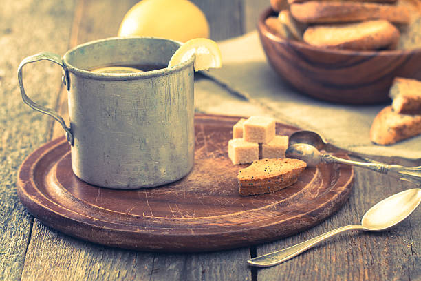 istock metal cup of tea, brown sugar, crackers and lemon 498467398