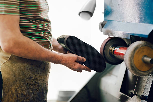istock Shoemaker polishing Shoes on the machine 498467848