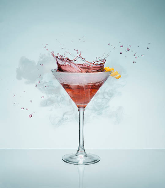 Celebration Concept Smoking and splashing cocktail. Creative concept image for celebrations, parties, birthdays etc fruit garnish stock pictures, royalty-free photos & images