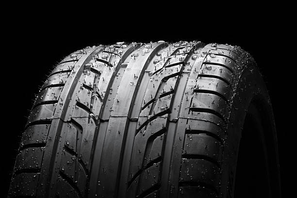 istock Wet car tire on black macro 498473589