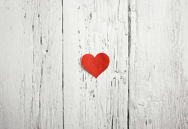 istock Heart on white wood background 498475155