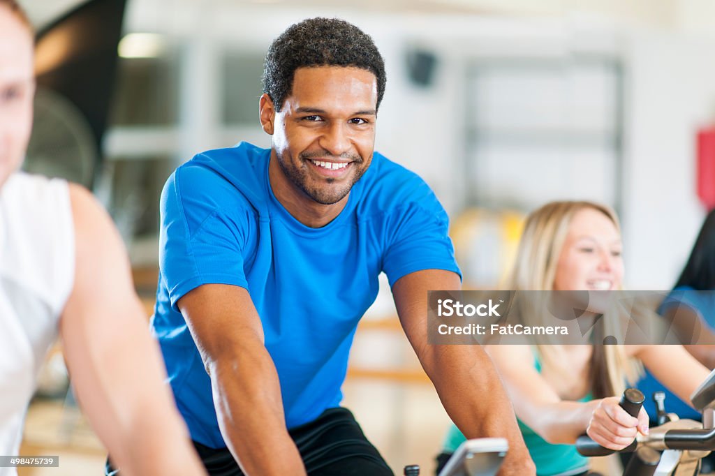 Biking at Gym A health club exercising class. 20-24 Years Stock Photo