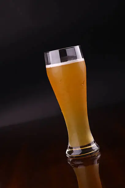 Glass of wheat bear over a dark background