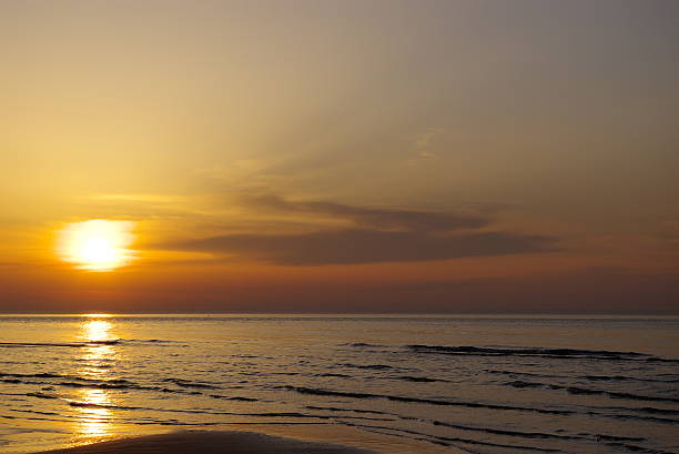 istock Beautiful orange blue sunset at Baltic sea with sun left 498477331