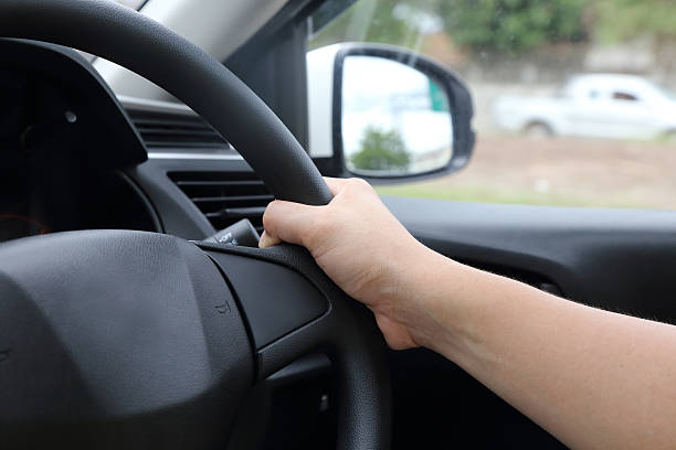 istock background of a male hand on steering wheel 498477611
