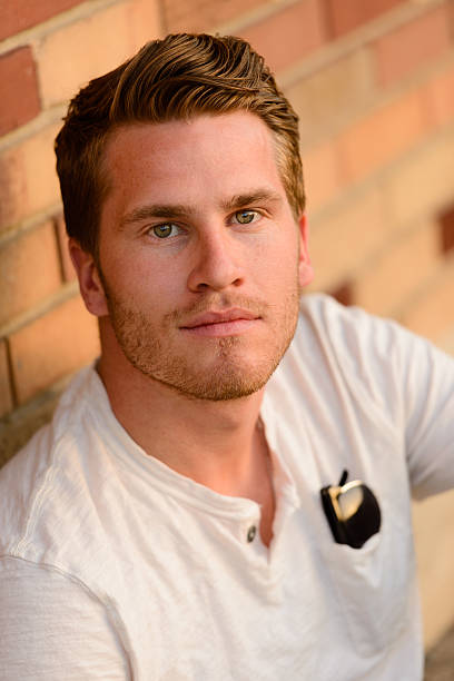 istock Headshot Of A College Student While Sitting By Brickwall 498488543