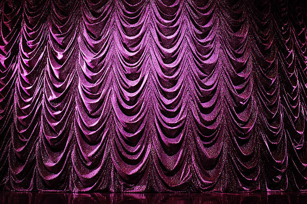 istock Brightly lit curtains in theatre 498488855