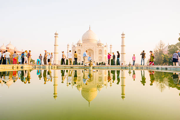 Taj Mahal reflection Tourists visit the Taj Mahal, Agra, India agra stock pictures, royalty-free photos & images