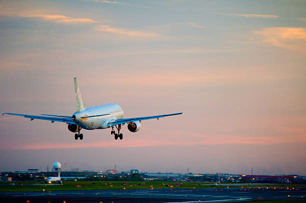 istock passenger plane fly up over take-off runway from airport 498490757