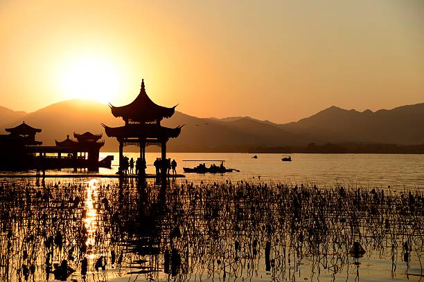 Chinese temple in west lake with sunset