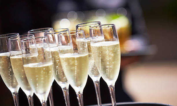 Glasses full of champagne on a tray Champagne drinks being served on a tray champagne region photos stock pictures, royalty-free photos & images