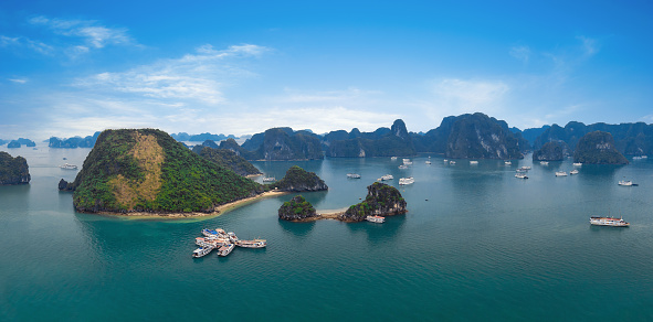 Panorama of Halong Bay Vietnam. Panoramic view of Ha Long islands, tourist junks, rock mountains and tropical sea water of famous landmark in Asia