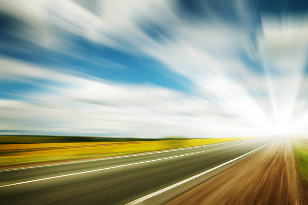istock Road through the yellow sunflower field 498493139