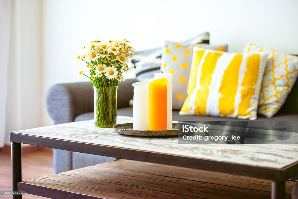 Sofa Modern wooden coffee table and cozy sofa with pillows. Living room interior and home decor concept Living Room Stock Photo