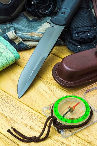 istock Knife surrounded by tourist equipment 498493593