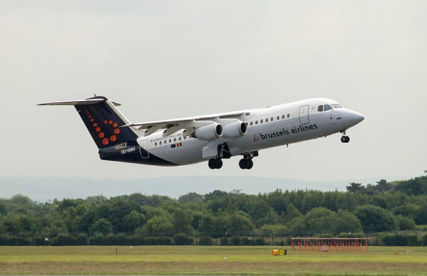 Brussels Airlines Avro 146 RJ100 Manchester, United Kingdom - June 14, 2014: Brussels Airlines Avro 146 RJ100 taking off from Manchester International Airport. Brussels Airlines has increased it's passenger figures five consecutive months. british aerospace stock pictures, royalty-free photos & images