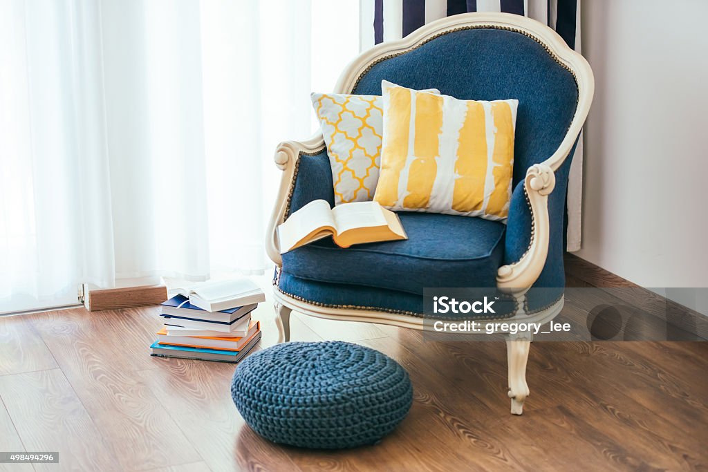 Armchair Cozy armchair with open book and decorative pillows. Interior and home decor concept Comfortable Stock Photo