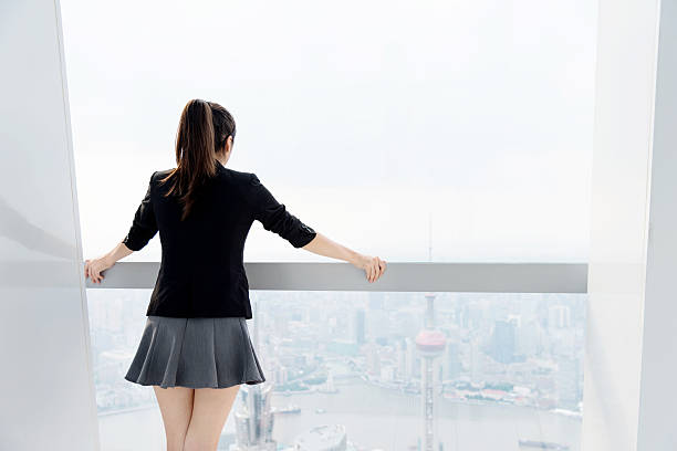 istock Businesswoman looking through the window 498494536