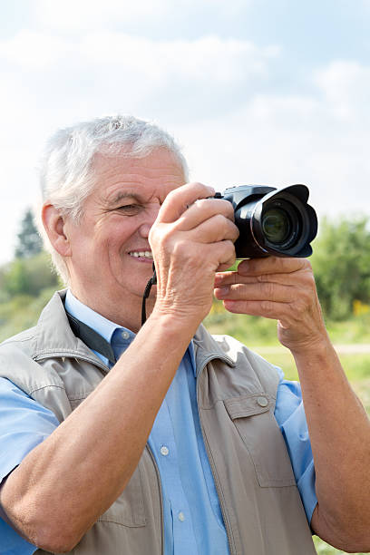 istock Senior man taking photos with camera 498494742