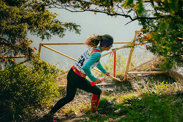 Runner girl is making sit ups on the city stairs till her girlfriend is jumping