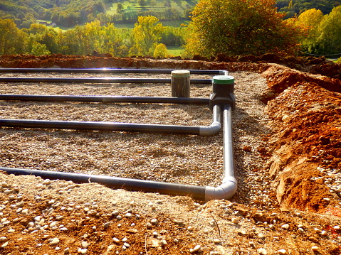 The top layer of pipework, after the membrane, sand and gravel had been applied, during the construction of a sand and gravel drainage system