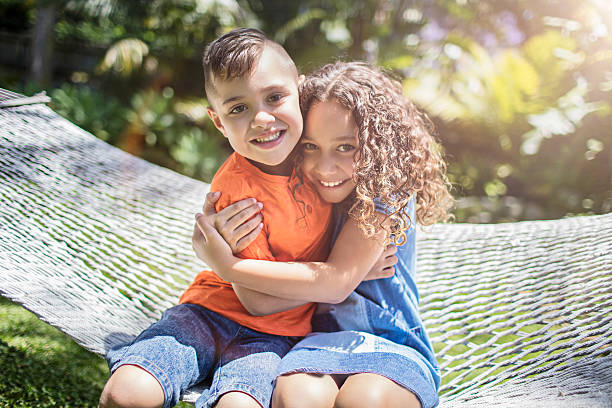 Aboriginal australian siblings hugging in the garden