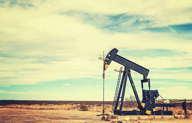 Vintage toned picture of an oil pump jack, Texas, USA.