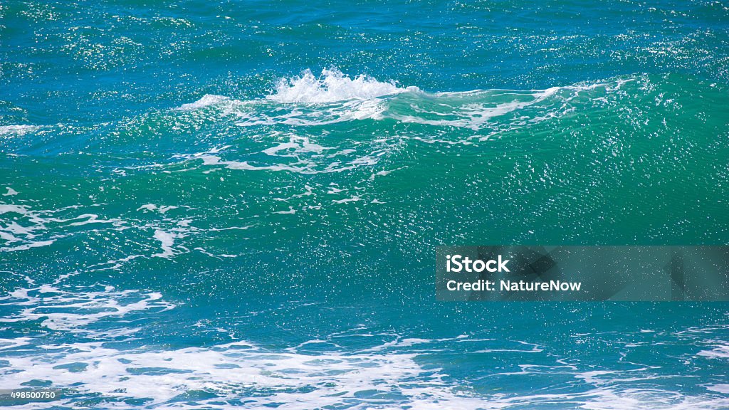 Blue wave Wave on a Sardinian beach on a windy day. 2015 Stock Photo