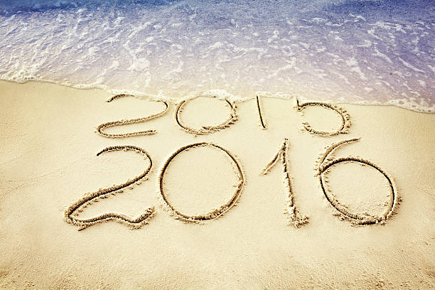 istock New Year 2016 replace 2015 concept on the sea beach 498502184