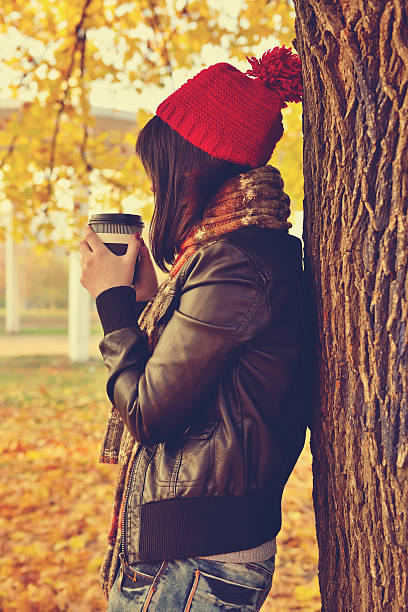 istock Girl in red cap drinking coffee 498504528