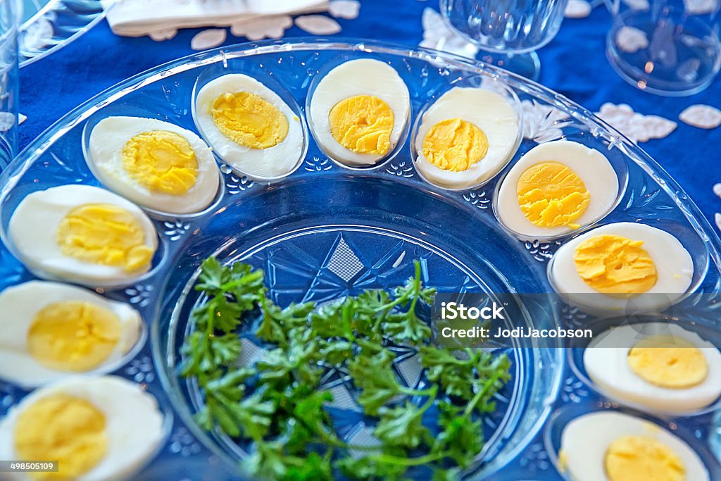 Hard boiled eggs at a traditional Passover seder Platter of hard boiled eggs and parsley on a table set for a traditional passover seder. RM Seder Stock Photo