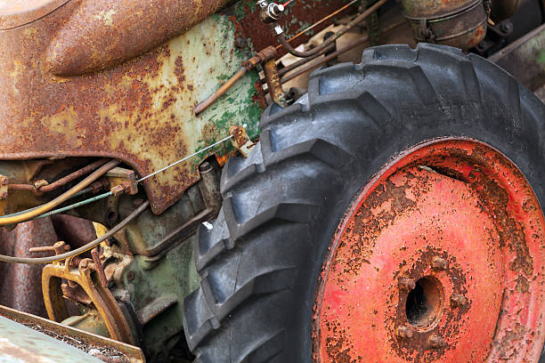 istock Fragment of old rusted tractor with red wheel 498505817